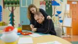 Woman teaching man.